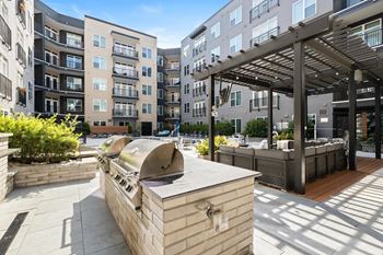 Outdoor tv lounge with kitchen and gas grills